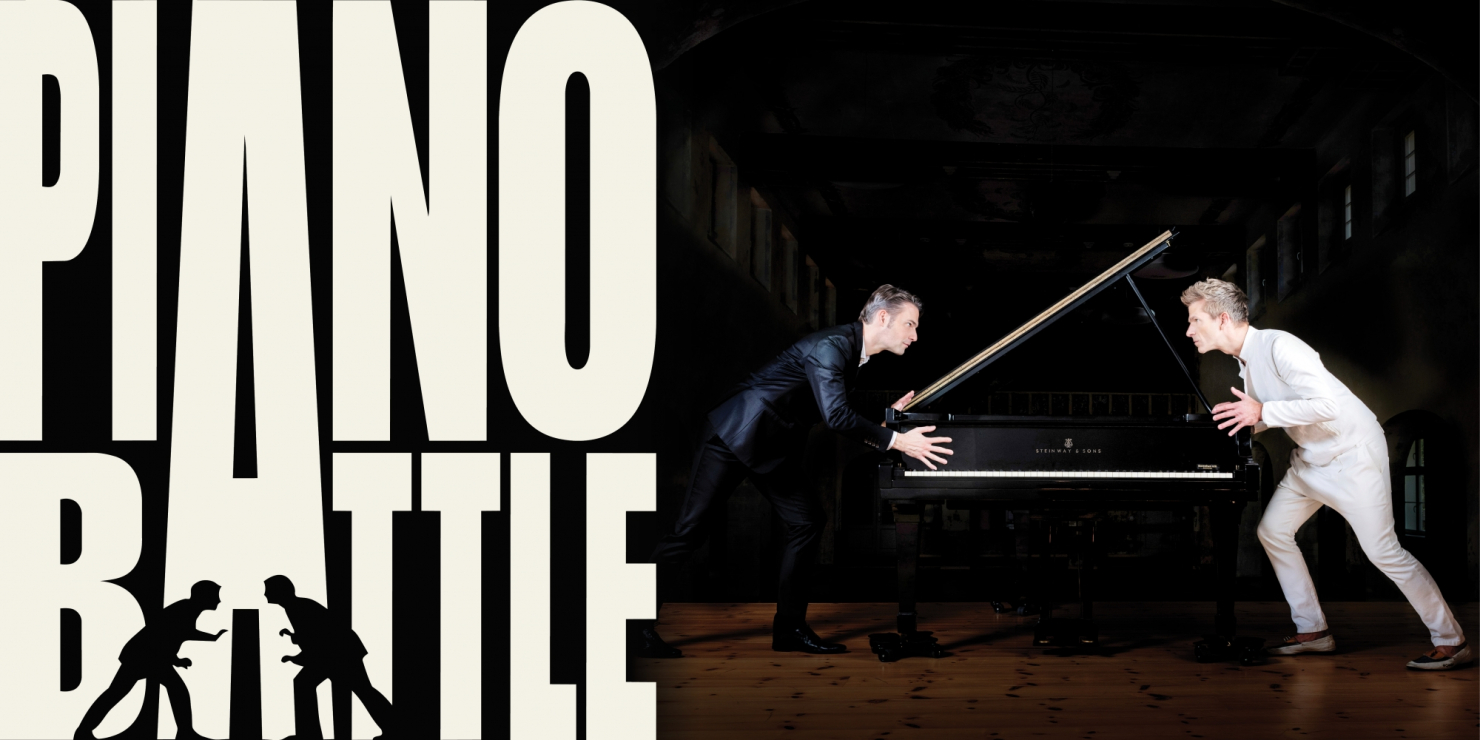 two men face to face across a piano, clearly in battle-mode