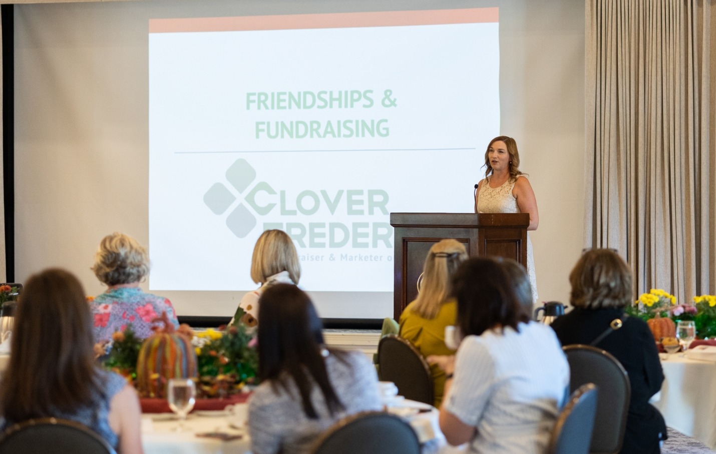 photo of clover Frederick wearing a white shirt speaking to the Friends of Lied board of directors. 